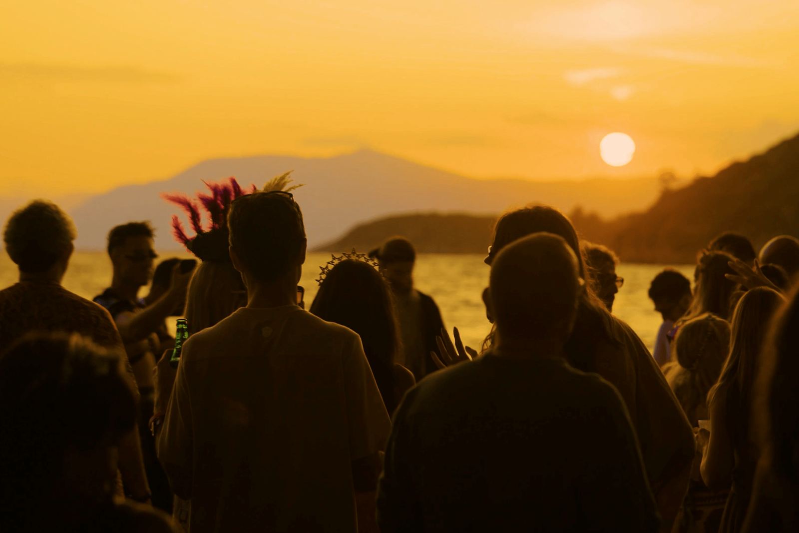 Silhouetted crowd watching the sun set over Bonjuk Bay