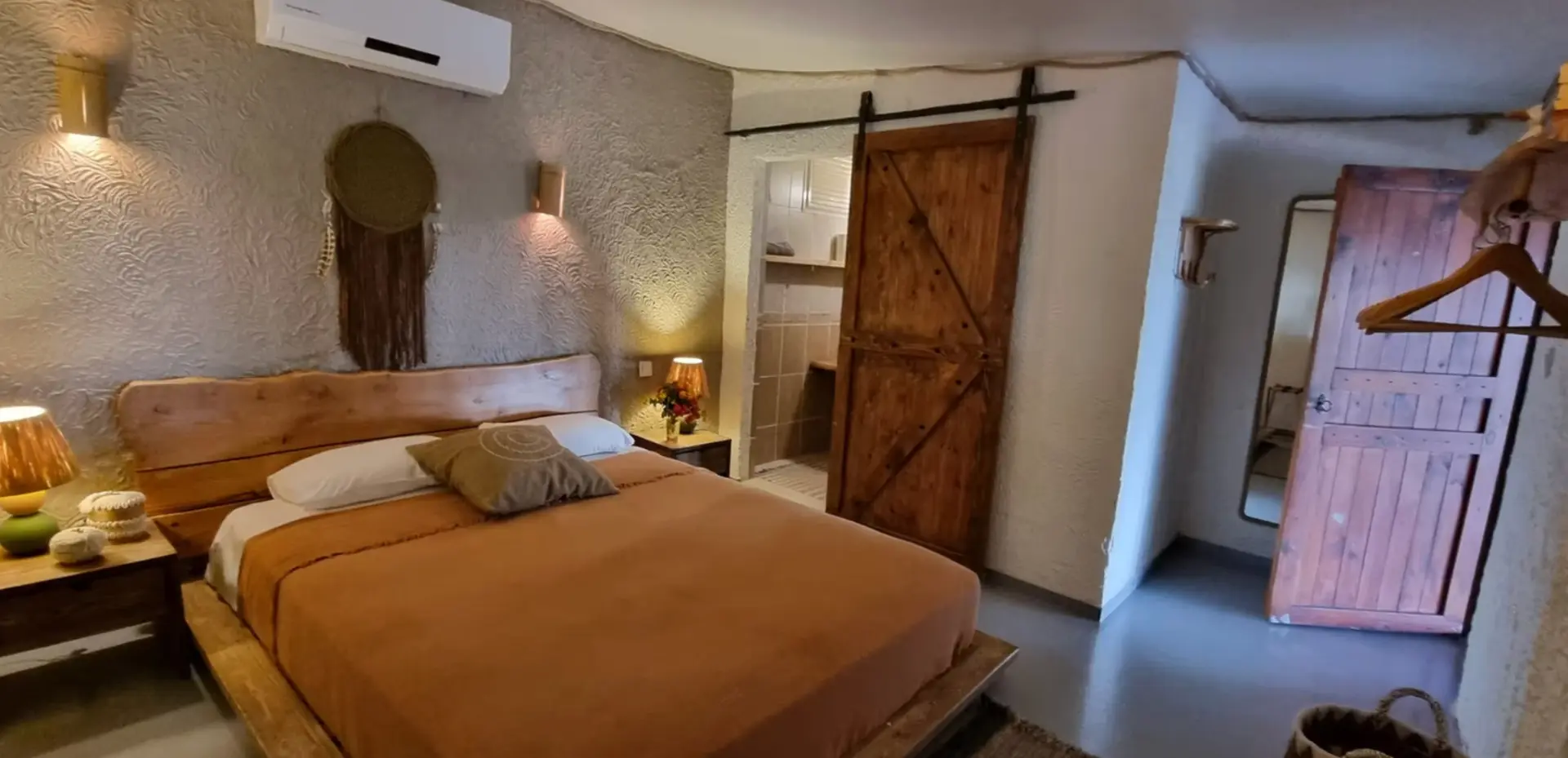 Sea front room with sliding barn door leading to a private bathroom