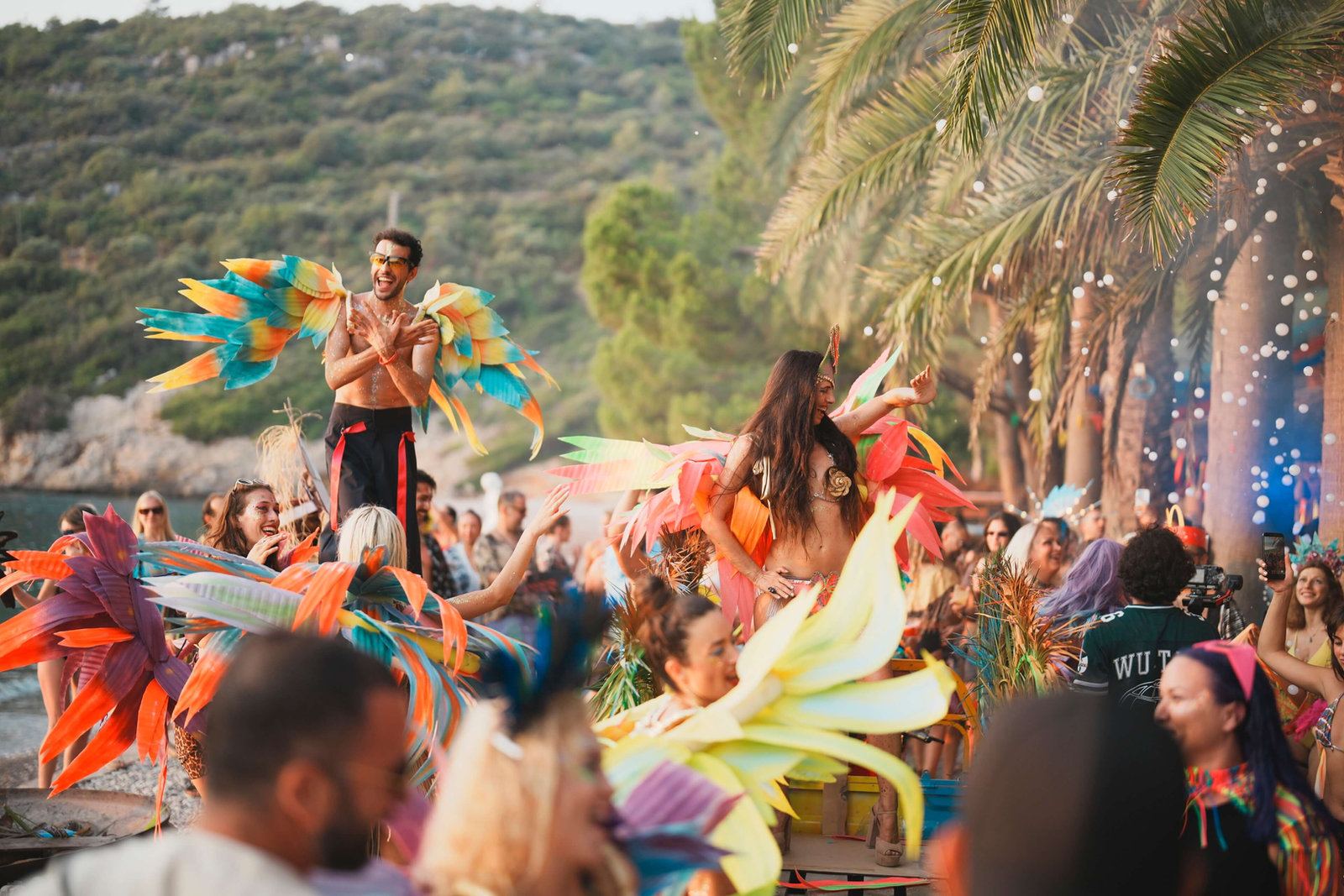 Carnival performers in feathered costumes among the crowd
