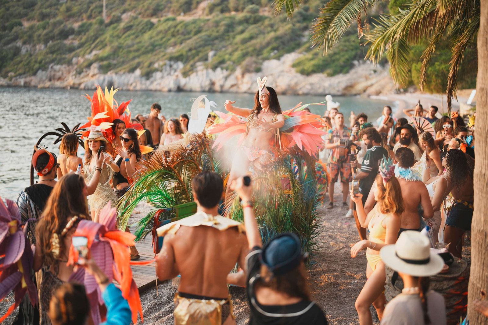 Colourful costumed parade along the shoreline of the bay