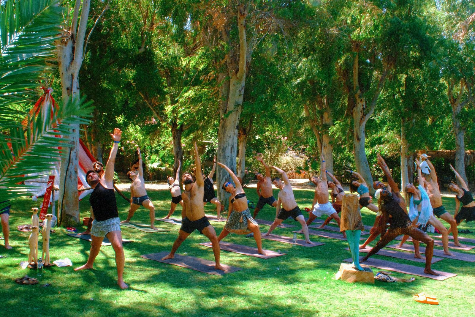 Group yoga session in a grove of trees at Bonjuk Bay