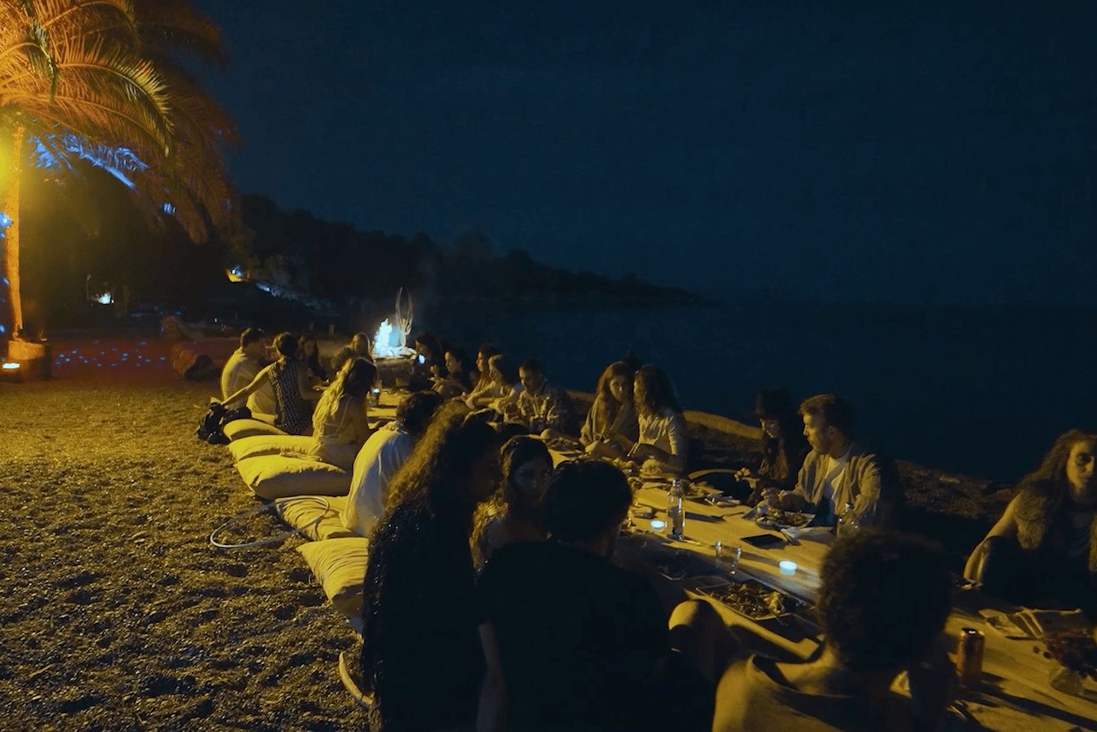 Night-time dinner set out along the water's edge